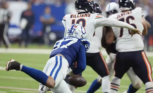 Indianapolis Colts defensive end Laiatu Latu (97) knows the ball away from Chicago Bears quarterback Caleb Williams (18) during the second half of an NFL football game Sunday, Sept. 22, 2024, in Indianapolis. (AP Photo/Darron Cummings)