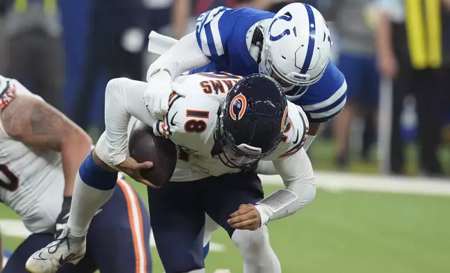 Chicago Bears quarterback Caleb Williams (18) is sacked by Indianapolis Colts defensive tackle Taven Bryan (96) during the first half of an NFL football game Sunday, Sept. 22, 2024, in Indianapolis. (AP Photo/Darron Cummings)