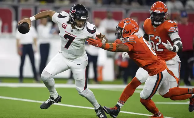 Houston Texans quarterback C.J. Stroud (7) scrambles away from Chicago Bears defensive back Kyler Gordon during the first half of an NFL football game Sunday, Sept. 15, 2024, in Houston. (AP Photo/Eric Christian Smith)