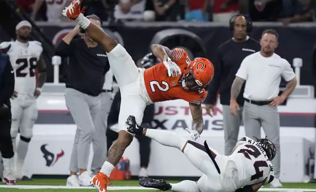 Houston Texans cornerback Derek Stingley Jr. (24) intercepts a pass intended for Chicago Bears wide receiver DJ Moore (2) during the second half of an NFL football game Sunday, Sept. 15, 2024, in Houston. (AP Photo/Eric Gay)