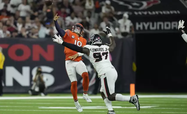 Chicago Bears quarterback Caleb Williams (18) throws over Houston Texans defensive tackle Mario Edwards Jr. (97) during the second half of an NFL football game Sunday, Sept. 15, 2024, in Houston. (AP Photo/Eric Christian Smith)