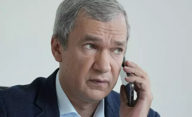 FILE - Belarusian dissident Pavel Latushka, a prominent opposition figure in exile, talks on the phone in Warsaw, Poland, on Aug. 2, 2021. (AP Photo/Czarek Sokolowski, File)