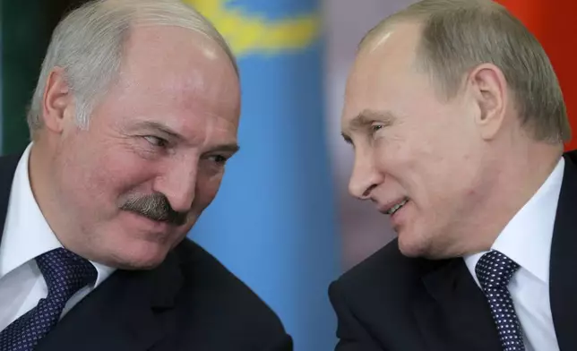 FILE - Russian President Vladimir Putin, right, and his Belarus counterpart, Alexander Lukashenko, talk at an economic summit in the Kremlin, in Moscow, Russia, on Dec. 23, 2014. (AP Photo/ Maxim Shipenkov, Pool, File)