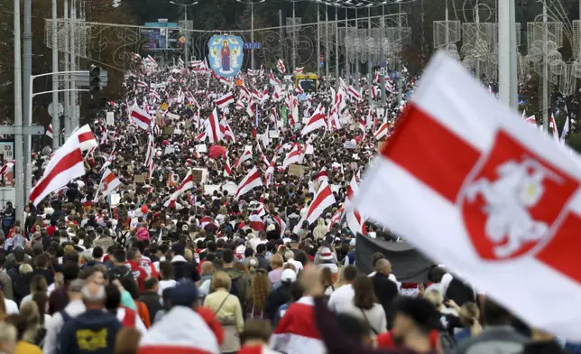 FILE - Protesters with old Belarusian national flags march at an opposition rally in Minsk, Belarus, on Sept. 6, 2020. (AP Photo, File)