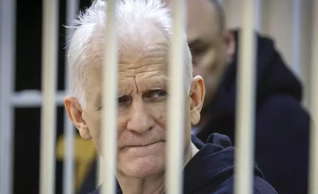 FILE - Ales Bialiatski, the head of the Viasna human rights group, sits in a defendants' cage at a court session in Minsk, Belarus, on Jan. 5, 2023. (Vitaly Pivovarchyk/BelTA Pool Photo via AP, File)