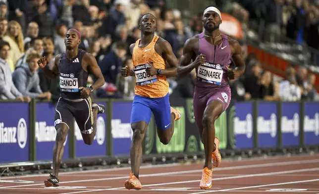 Kenneth Bednarek, of the United States, Letsile Tebogo, of Botswana, and Alexander Ogando, of the Dominican Republic, from right, cross the finish line in the men's 200 meters during the Diamond League final 2024 athletics meet in Brussels, Saturday, Sept. 14, 2024. (AP Photo/Frederic Sierakowski)