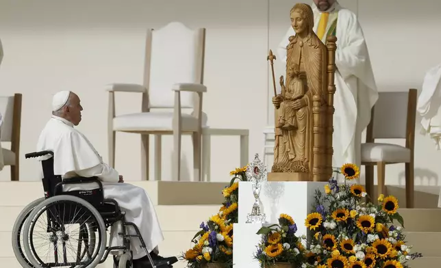 Pope Francis sits on his wheelchair as he presides over the Sunday mass at King Baudouin Stadium, in Brussels Sunday, Sept. 29, 2024. (AP Photo/Omar Havana)