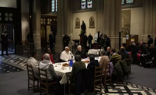 Pope Francis have a breakfast together with people who are experiencing homelessness and are assisted by the parish church of St. Gilles in Brussels, Saturday, Sept. 28, 2024. (AP Photo/Andrew Medichini)