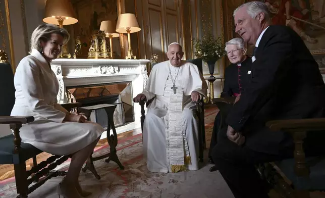 Pope Francis, center, talks to King Philippe of Belgium, right, and Queen Mathilde at the Castle of Laeken, Belgium, Friday, Sept. 26, 2024, on the second day of a four-day apostolic journey to Luxembourg and Belgium. (Alberto Pizzoli/pool photo via AP)