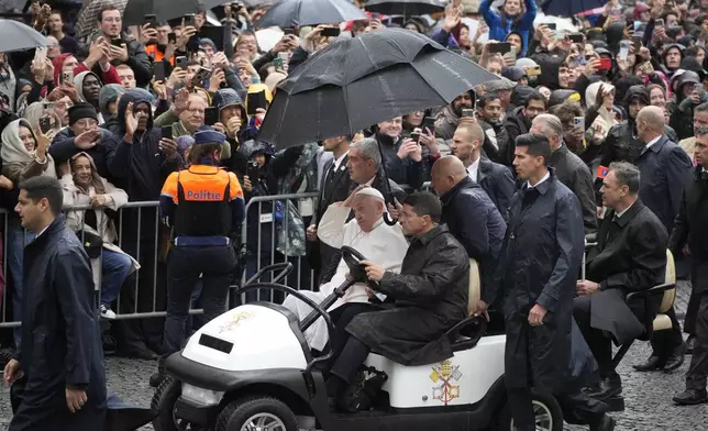 Pope Francis gestures during a tours in an open car among the faithful in the Groet Markt in Leuven, Belgium, on the second day of his four-day visit to Luxembourg and Belgium, Friday, Sept. 27, 2024. (AP Photo/Andrew Medichini)