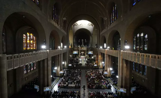 Faithful gather in the Koekelberg Basilica of the Sacred Heart during the meeting of Pope Francis with bishops, deacons, and religious people, in Brussels, Saturday, Sept. 28, 2024. (AP Photo/Andrew Medichini)