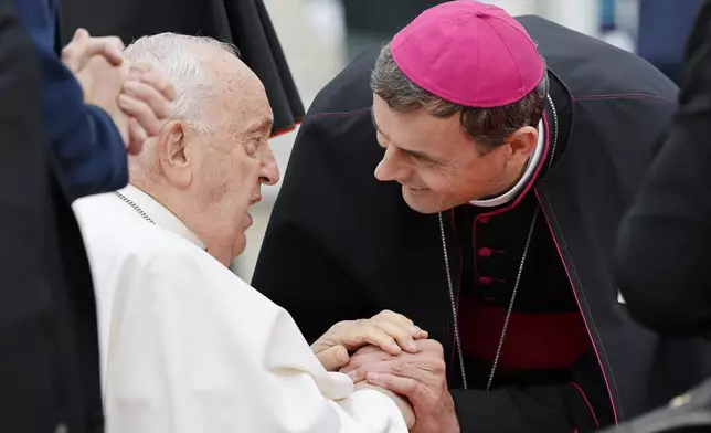 Pope Francis is greeted by Archbishop Luc Terlinden during the farewell ceremony at Melsbroek Air Base at the end of a four-day visit to Belgium and Luxembourg, Sunday, Sept. 29, 2024. (AP Photo/Geert Vanden Wijngaert)