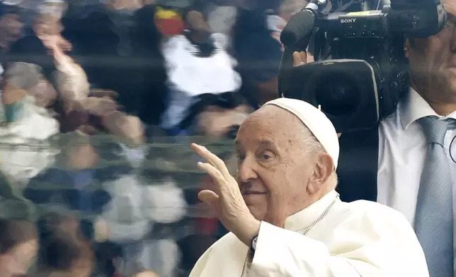 Pope Francis waves as he arrives to lead the holy mass , at the King Baudouin stadium in Brussels, Belgium, Sunday, Sept. 29, 2024. (AP Photo/Omar Havana)