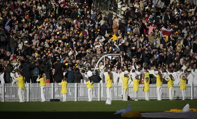 Pope Francis is cheered by faithful as he arrives to preside over the Sunday mass in King Baudouin Stadium, in Brussels Sunday, Sept. 29, 2024. (AP Photo/Andrew Medichini)