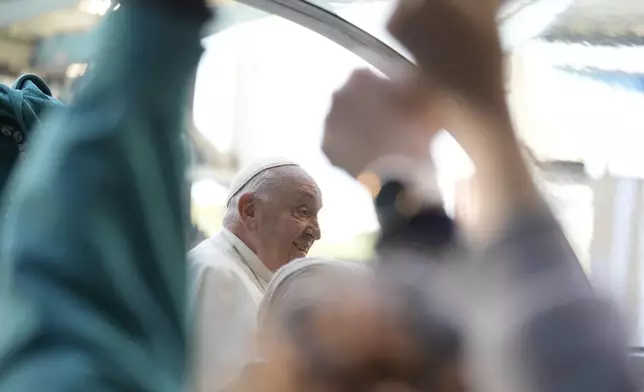 Pope Francis is cheered by faithful as he arrives to preside over the Sunday mass in King Baudouin Stadium, in Brussels Sunday, Sept. 29, 2024. (AP Photo/Andrew Medichini)