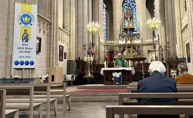 Priest Guy De Keersmaecker, center, leads a service with parishioners at the St. Martin's Basilica, in Halle, Belgium, Friday, Sept. 6, 2024. (AP Photo/Raf Casert)