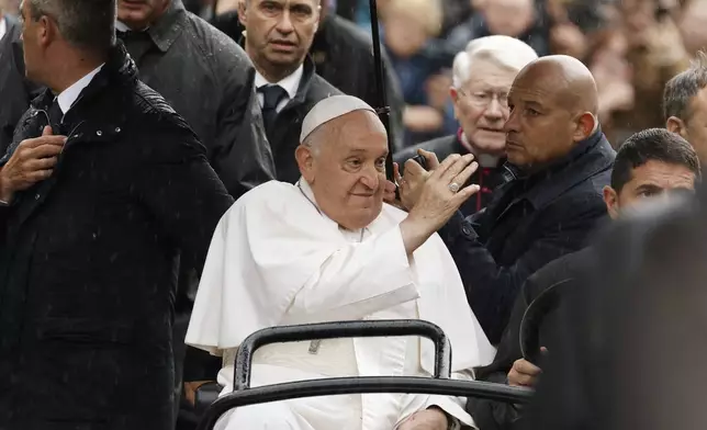 Pope Francis waves during a tours in an open car among the faithful in the Groet Markt in Leuven, Belgium, on the second day of his four-day visit to Luxembourg and Belgium, Friday, Sept. 27, 2024. (AP Photo/Omar Havana)