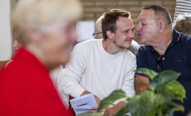 Parishioners show gratitude and connection during a service at the Don Bosco church in Buizingen, Belgium, Sunday, Sept. 8, 2024. (AP Photo/Geert Vanden Wijngaert)