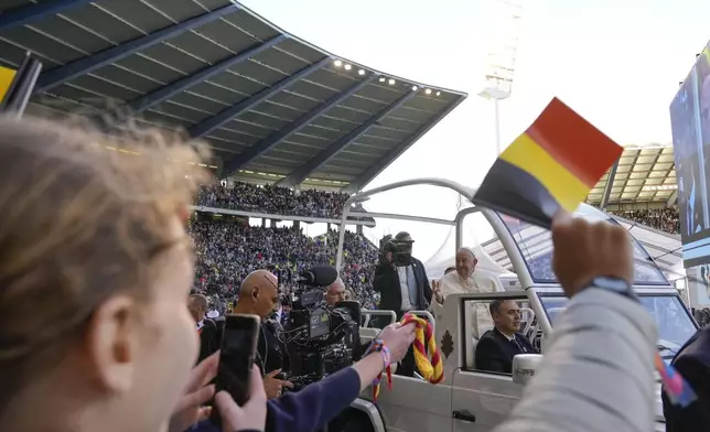 Pope Francis is cheered by faithful as he arrives to preside over the Sunday mass at King Baudouin Stadium, in Brussels Sunday, Sept. 29, 2024. (AP Photo/Andrew Medichini)