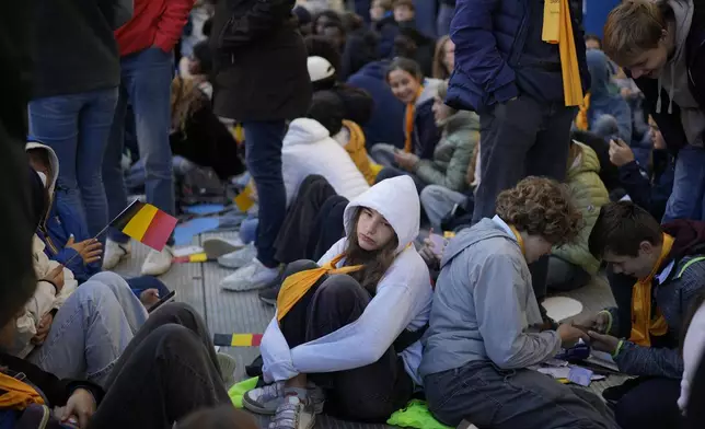 Faithful wait for the start of a mass presided by Pope Francis at King Baudouin Stadium, in Brussels Sunday, Sept. 29, 2024. (AP Photo/Andrew Medichini)