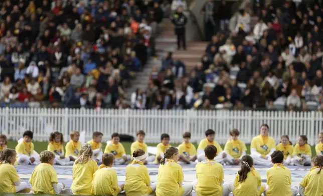 Kids listen Pope Francis as he presides the holy mass , at the King Baudouin stadium in Brussels, Belgium, Sunday, Sept. 29, 2024. (AP Photo/Omar Havana)