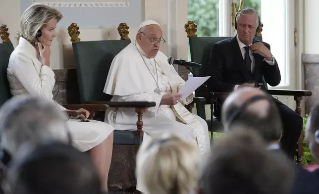 Pope Francis flanked by King Philippe and Queen Mathilde delivers his message during a meeting with the authorities and the civil society in the Grande Galerie of the Castle of Laeken, Brussels, Friday, Sept. 27, 2024. (AP Photo/Andrew Medichini)