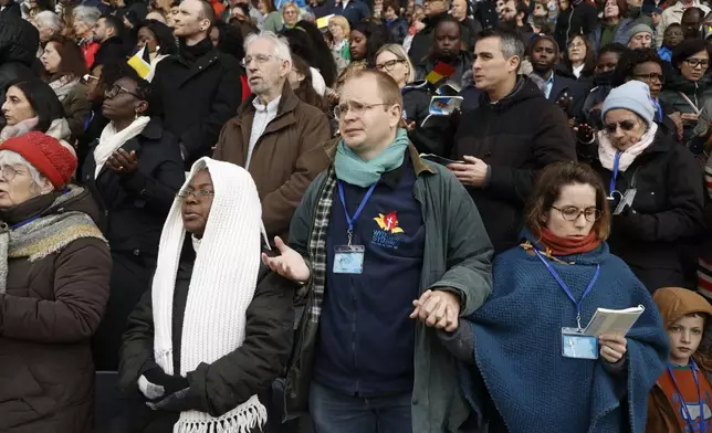 Faithful listen as Pope Francis presides the holy mass , at the King Baudouin stadium in Brussels, Belgium, Sunday, Sept. 29, 2024. (AP Photo/Omar Havana)