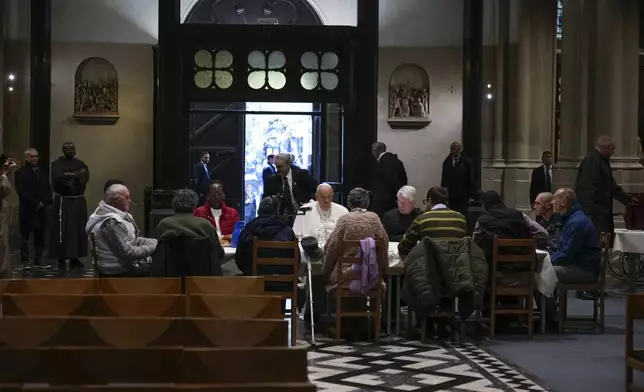 Pope Francis have a breakfast together with people who are experiencing homelessness and are assisted by the parish church of St. Gilles in Brussels, Saturday, Sept. 28, 2024. (AP Photo/Andrew Medichini)