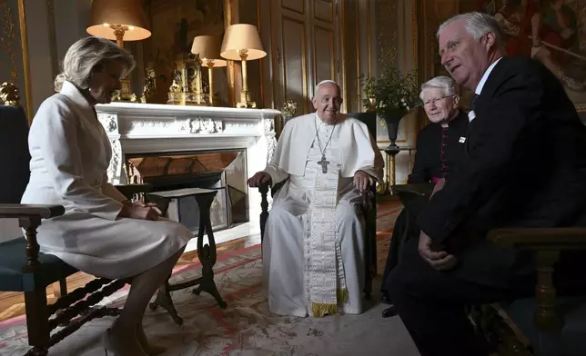 Pope Francis, center, talks to King Philippe of Belgium, right, and Queen Mathilde at the Castle of Laeken, Belgium, Friday, Sept. 26, 2024, on the second day of a four-day apostolic journey to Luxembourg and Belgium. (Alberto Pizzoli/pool photo via AP)