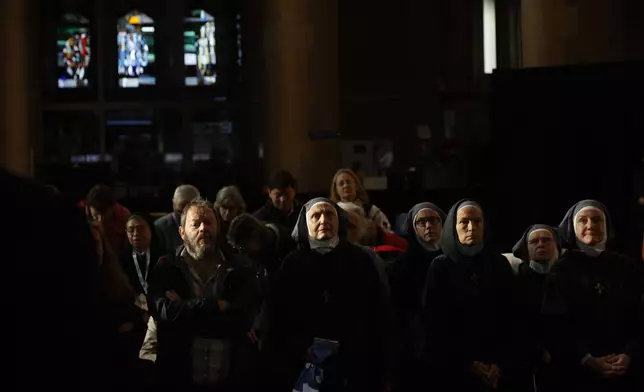 Nuns attend a meeting of Pope Francis with bishops, deacons, and religious people in Koekelberg Basilica of the Sacred Heart, in Koekelberg, Belgium, Saturday Sept. 28, 2024. (AP Photo/Omar Havana)