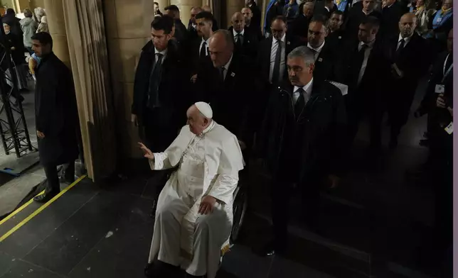 Pope Francis leaves after attending a meeting with bishops, deacons, and religious people in Koekelberg Basilica of the Sacred Heart, in Koekelberg, Belgium, Saturday Sept. 28, 2024. (AP Photo/Omar Havana)