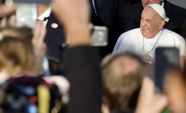 Pope Francis cheers faithful at the end of his meeting with students of the Louvain Catholic University in Ottignies-Louvain-la-Neuve, Belgium, Saturday, Sept. 28, 2024. (AP Photo/Geert Vanden Wijngaert)