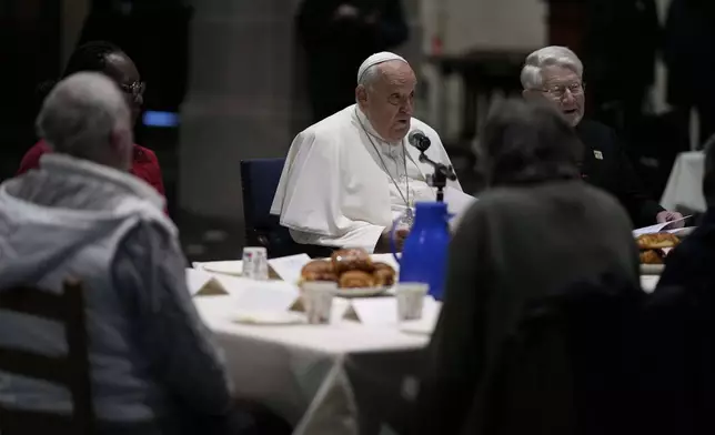 Pope Francis have a breakfast together with people who are experiencing homelessness and are assisted by the parish church of St. Gilles in Brussels, Saturday, Sept. 28, 2024. (AP Photo/Andrew Medichini)