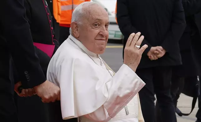 Pope Francis waves to photographers during the farewell ceremony at Melsbroek Air Base at the end of a four-day visit to Belgium and Luxembourg, Sunday, Sept. 29, 2024. (AP Photo/Geert Vanden Wijngaert)