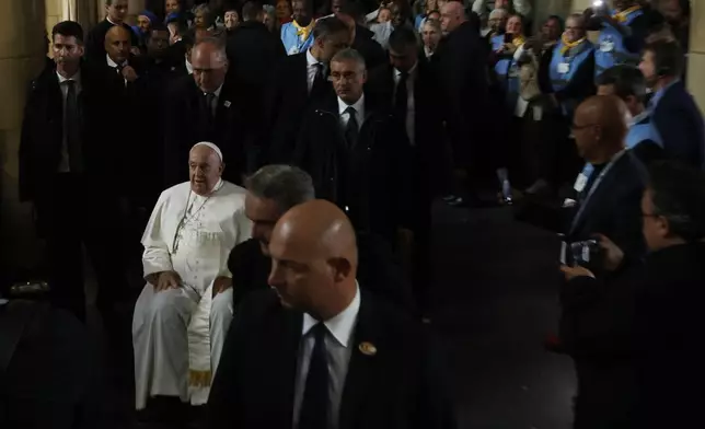 Pope Francis leaves after attending a meeting with bishops, deacons, and religious people in Koekelberg Basilica of the Sacred Heart, in Koekelberg, Belgium, Saturday Sept. 28, 2024. (AP Photo/Omar Havana)