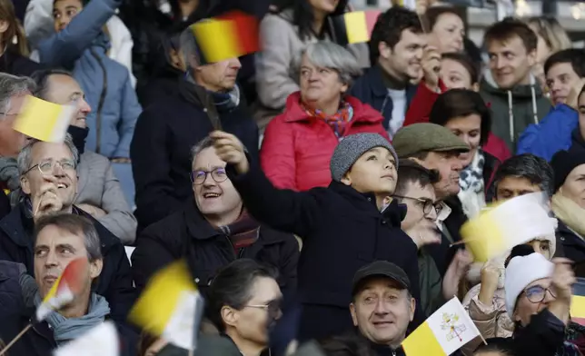 Faithful wave flags as Pope Francis arrives to lead the holy mass , at the King Baudouin stadium in Brussels, Belgium, Sunday, Sept. 29, 2024. (AP Photo/Omar Havana)
