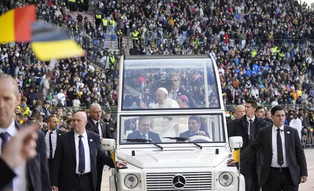 Pope Francis is cheered by faithful as he arrives to preside over the Sunday mass in King Baudouin Stadium, in Brussels Sunday, Sept. 29, 2024. (AP Photo/Andrew Medichini)