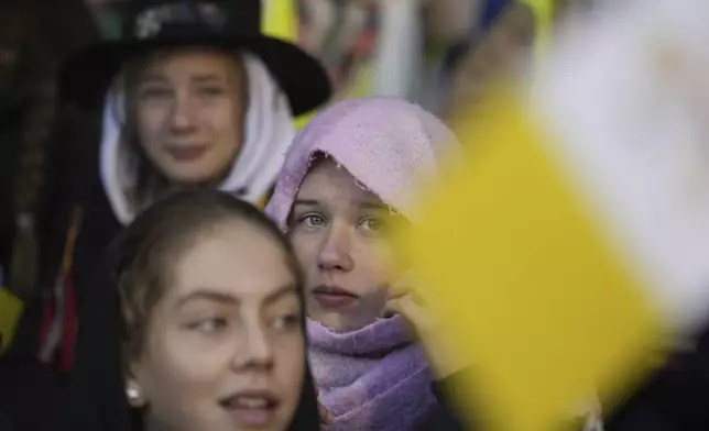 Faithful wait for the start of a mass presided by Pope Francis at King Baudouin Stadium, in Brussels Sunday, Sept. 29, 2024. (AP Photo/Andrew Medichini)