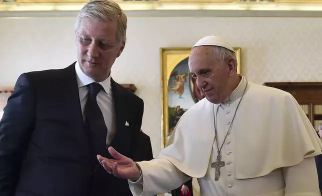 FILE -- Pope Francis, right, talks with Belgium's King Philippe during a private audience at the Vatican, Monday, March 9, 2015. (AP Photo/Gabriel Bouys, Pool, File)