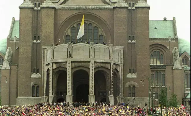 FILE -- Pope John Paul II is cheered as he passes the Basilica of Koekelberg in Brussels Sunday June 4, 1995, during a ceremony to beatify Belgian priest Father Damien De Vuester, who lived and died amongst the lepers of Hawaii during the 19th century. (AP Photo/Massimo Sambucetti, File)