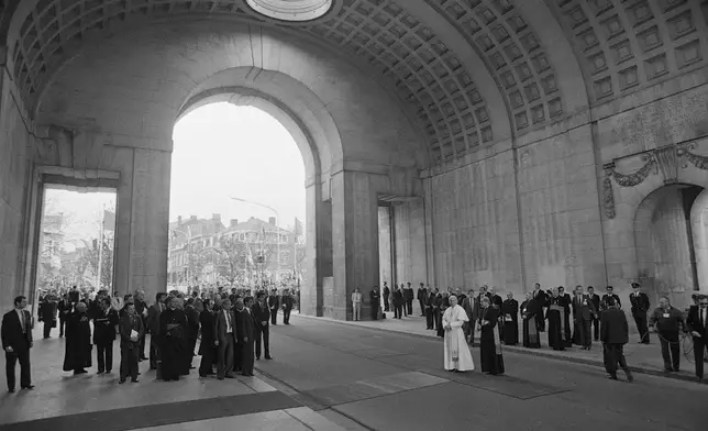 FILE -- Pope John Paul II stands underneath the huge bow of the Menen Gate, a war memorial for the dead of World War II, in Ieper, May 17, 1985, on his second day in Belgium. (AP Photo, File)