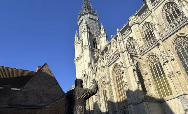 An exterior view of St. Martin's Basilica with the statue of 20th century Cardinal Jozef Cardijn, in Halle, Belgium, Sept. 15, 2024. (AP Photo/Raf Casert)