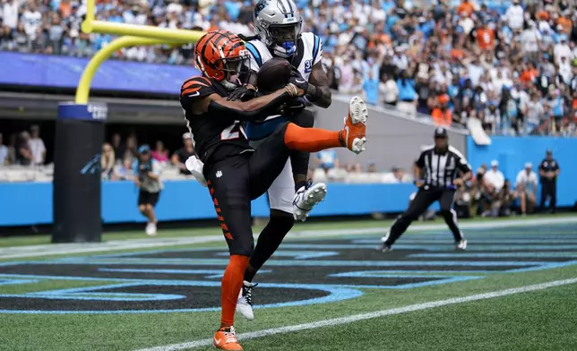 Cincinnati Bengals cornerback DJ Turner II breaks up a pass intended for Carolina Panthers wide receiver Diontae Johnson during the first half of an NFL football game, Sunday, Sept. 29, 2024, in Charlotte, N.C. (AP Photo/Erik Verduzco)