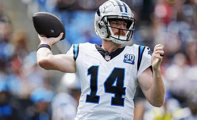 Carolina Panthers quarterback Andy Dalton passes against the Cincinnati Bengals during the first half of an NFL football game, Sunday, Sept. 29, 2024, in Charlotte, N.C. (AP Photo/Rusty Jones)