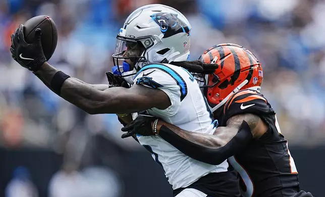 Carolina Panthers wide receiver Diontae Johnson catches a pass in front of Cincinnati Bengals cornerback DJ Turner II during the first half of an NFL football game, Sunday, Sept. 29, 2024, in Charlotte, N.C. (AP Photo/Rusty Jones)