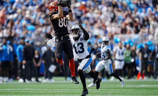 Cincinnati Bengals wide receiver Andrei Iosivas catches a pass in front of Carolina Panthers cornerback Troy Hill during the first half of an NFL football game, Sunday, Sept. 29, 2024, in Charlotte, N.C. (AP Photo/Rusty Jones)