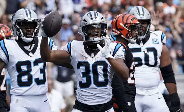 Carolina Panthers running back Chuba Hubbard celebrates after scoring against the Cincinnati Bengals during the first half of an NFL football game, Sunday, Sept. 29, 2024, in Charlotte, N.C. (AP Photo/Erik Verduzco)