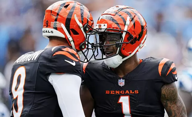 Cincinnati Bengals wide receiver Ja'Marr Chase celebrates after scoring with quarterback Joe Burrow against the Carolina Panthers during the first half of an NFL football game, Sunday, Sept. 29, 2024, in Charlotte, N.C. (AP Photo/Rusty Jones)