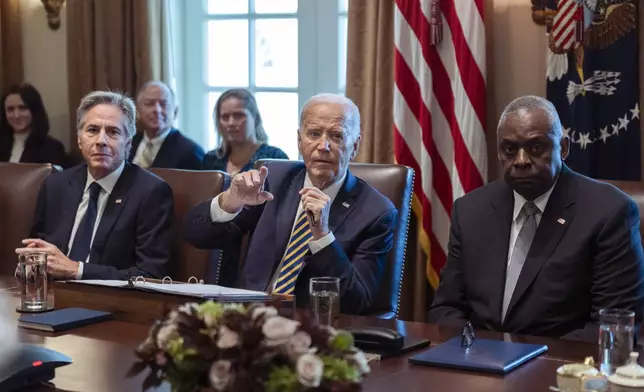 President Joe Biden flanked Secretary of State Antony Blinken, left, and Secretary of Defense Lloyd Austin, right, speaks during a meeting with the members of his cabinet and first lady Jill Biden, in the Cabinet Room of the White House, Friday, Sept. 20, 2024. (AP Photo/Manuel Balce Ceneta)