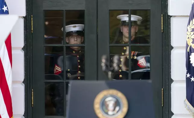 U.S. Marines prepare to open the doors for President Joe Biden and North Wales, Pa. Mayor Neil McDevitt on the South Lawn of the White House in Washington, Monday, Sept. 9, 2024, for an event to celebrate the Americans with Disabilities Act (ADA) and to mark Disability Pride Month.(AP Photo/Jose Luis Magana)